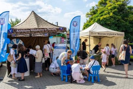 uczestnicy quizu przed stoiskiem